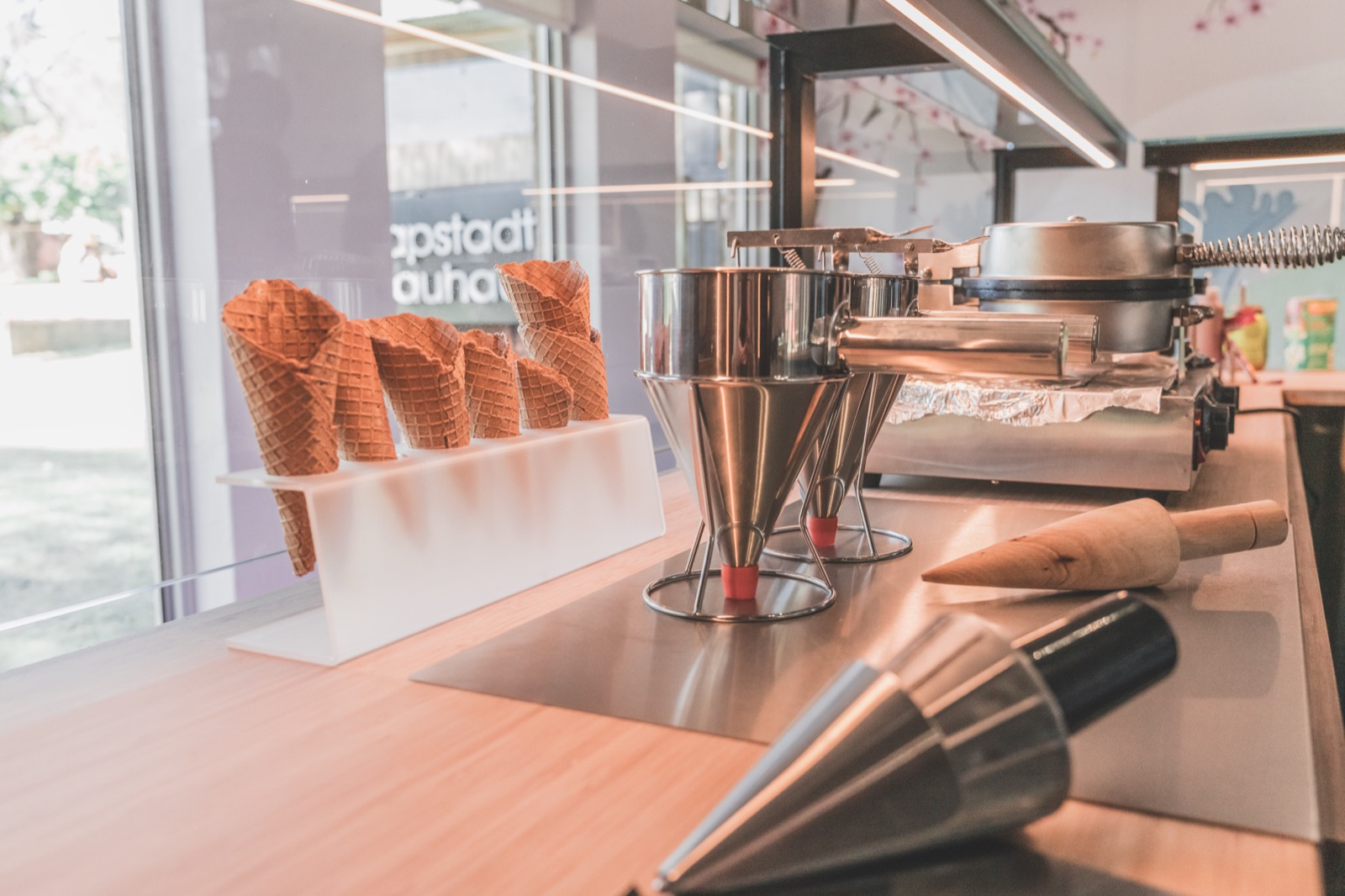 Fresh hand-rolled waffle cones and equipment