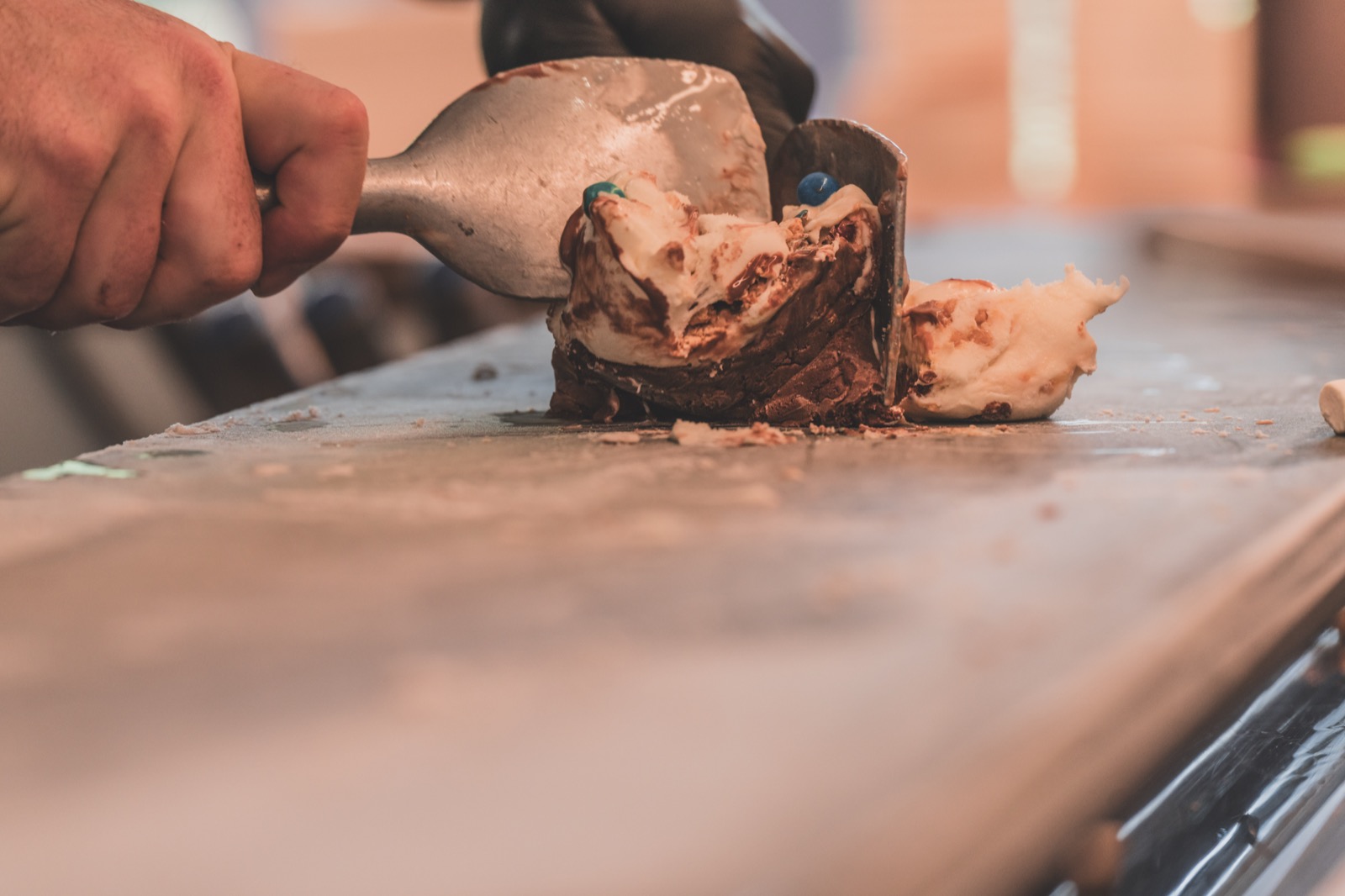 Ice cream being worked on the frozen slab