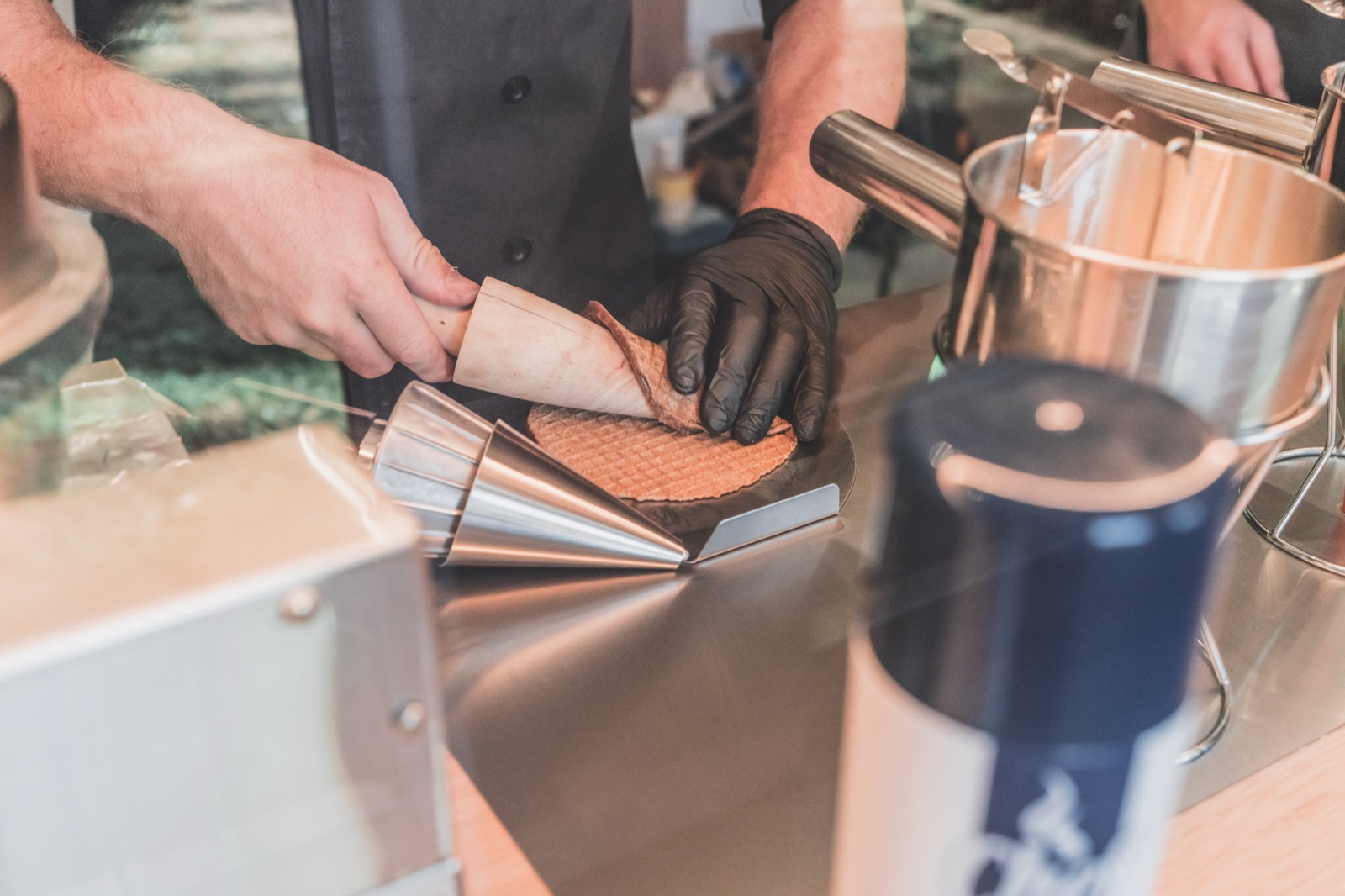 Hand-rolling a fresh waffle cone